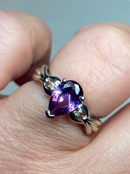 10k white gold ring with pear-shaped synthetic sapphire and diamonds.