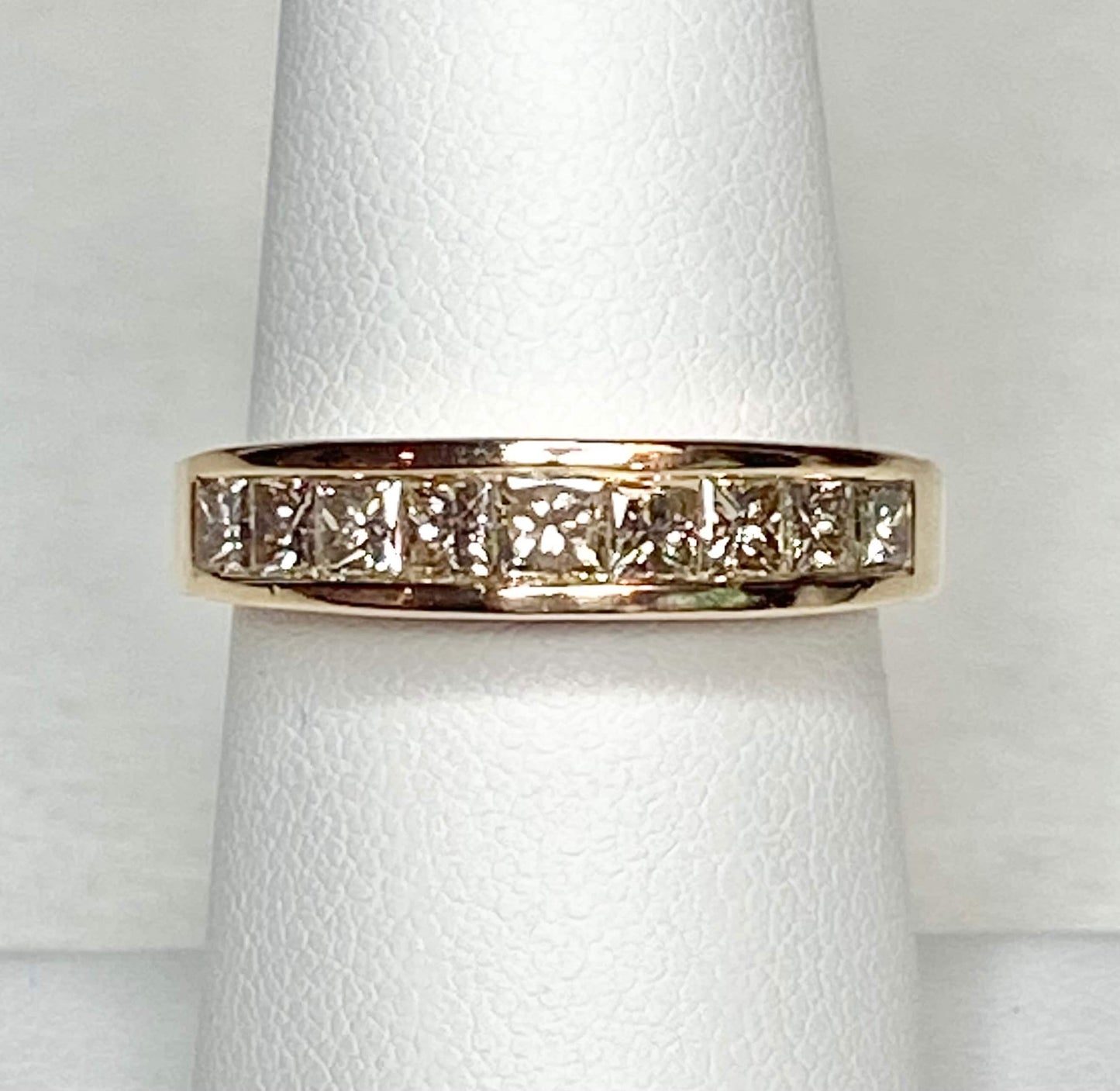 14k yellow gold anniversary band with princess cut diamonds.