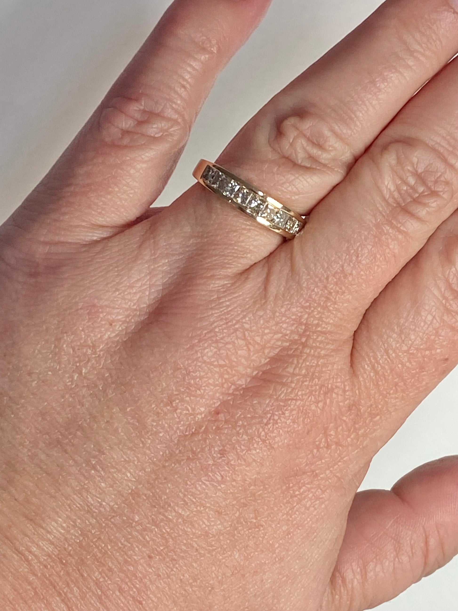 14k yellow gold anniversary ring with princess cut diamonds.