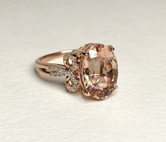 Solid 18k rose gold ring with oval morganite and diamond accents.