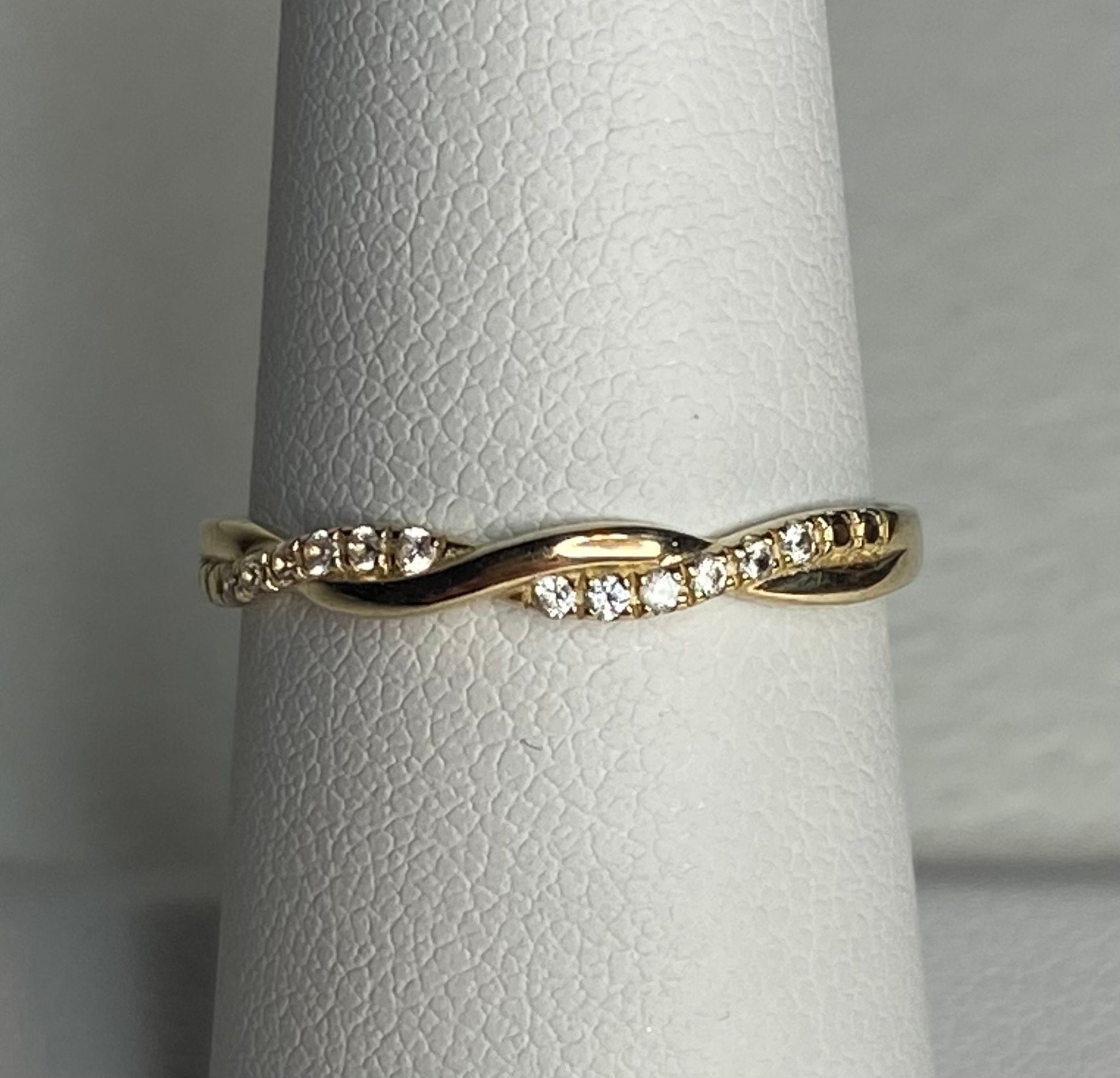 Solid 10k yellow gold twist band ring with pave stones.
