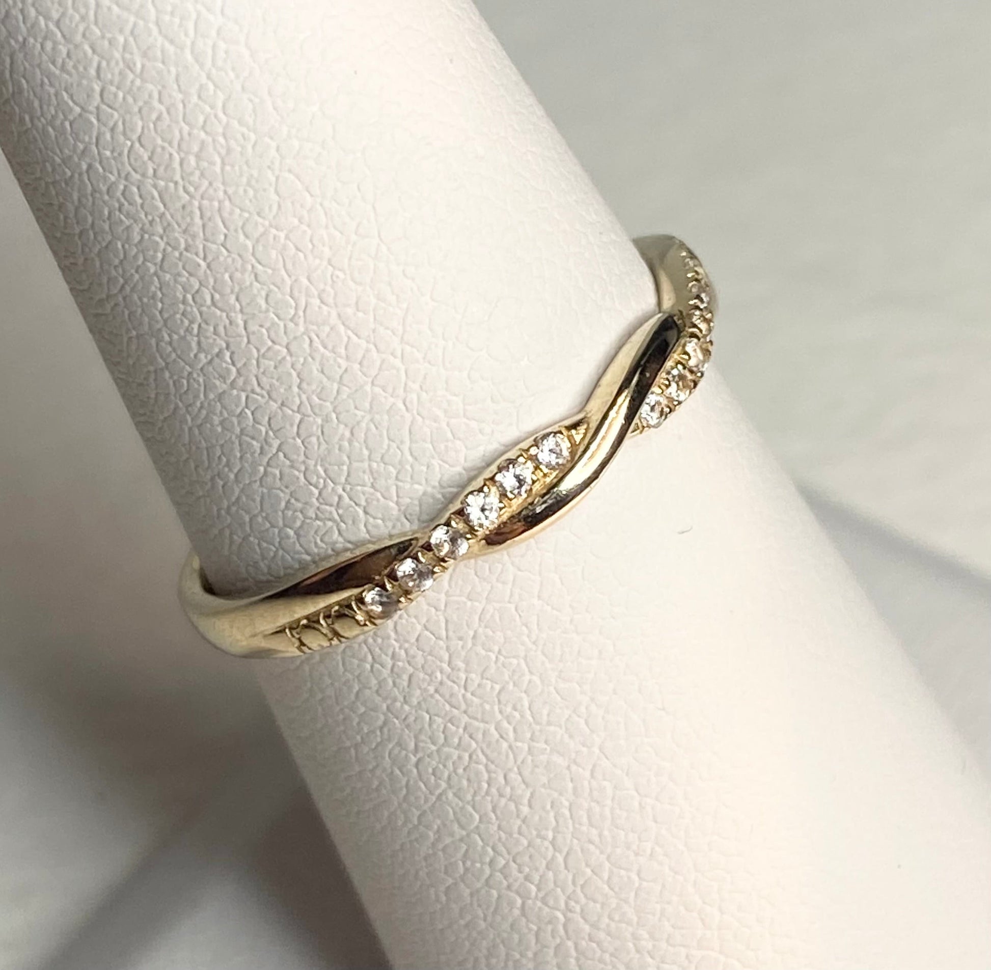 Solid 10k yellow gold twist band ring with pave stones.