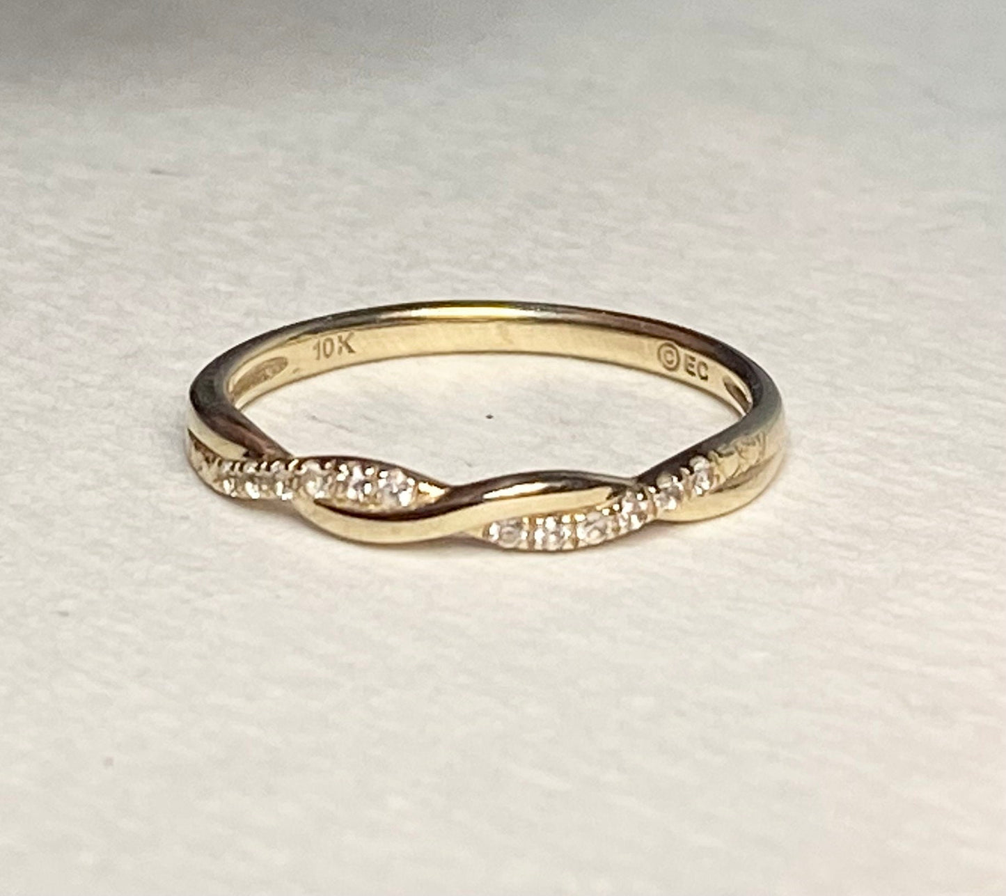 Solid 10k gold twisted band ring with pave stones.