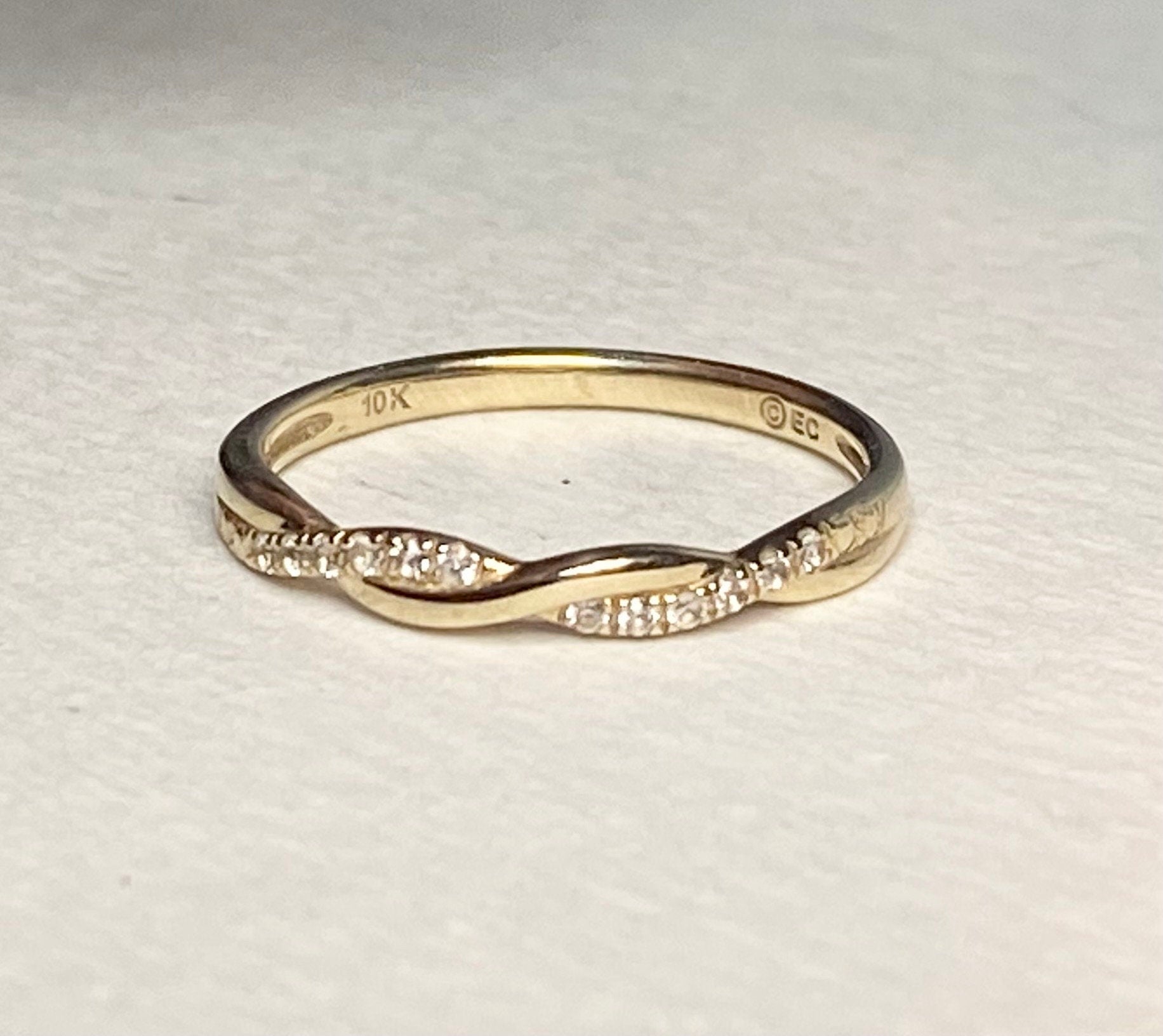 Solid 10k gold twisted band ring with pave stones.