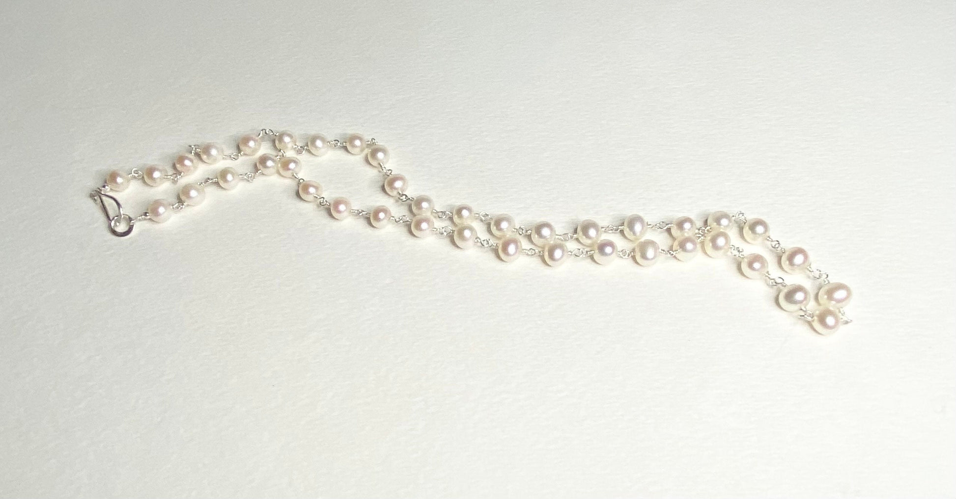 Lustrous genuine cultured freshwater pearl necklace in solid sterling silver.