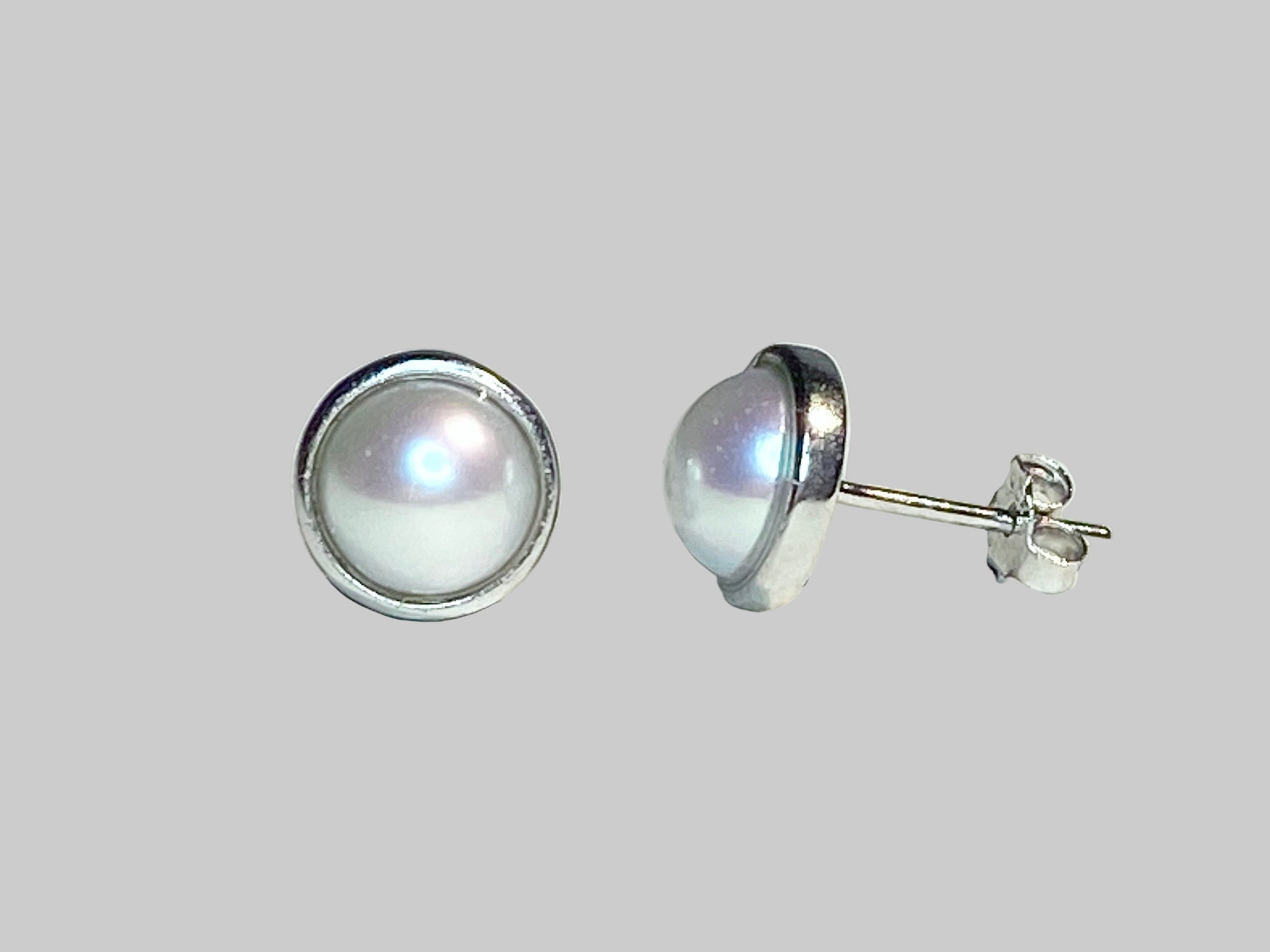 Genuine 6.5mm cultured pearl halves in sterling silver bezel stud earrings.
