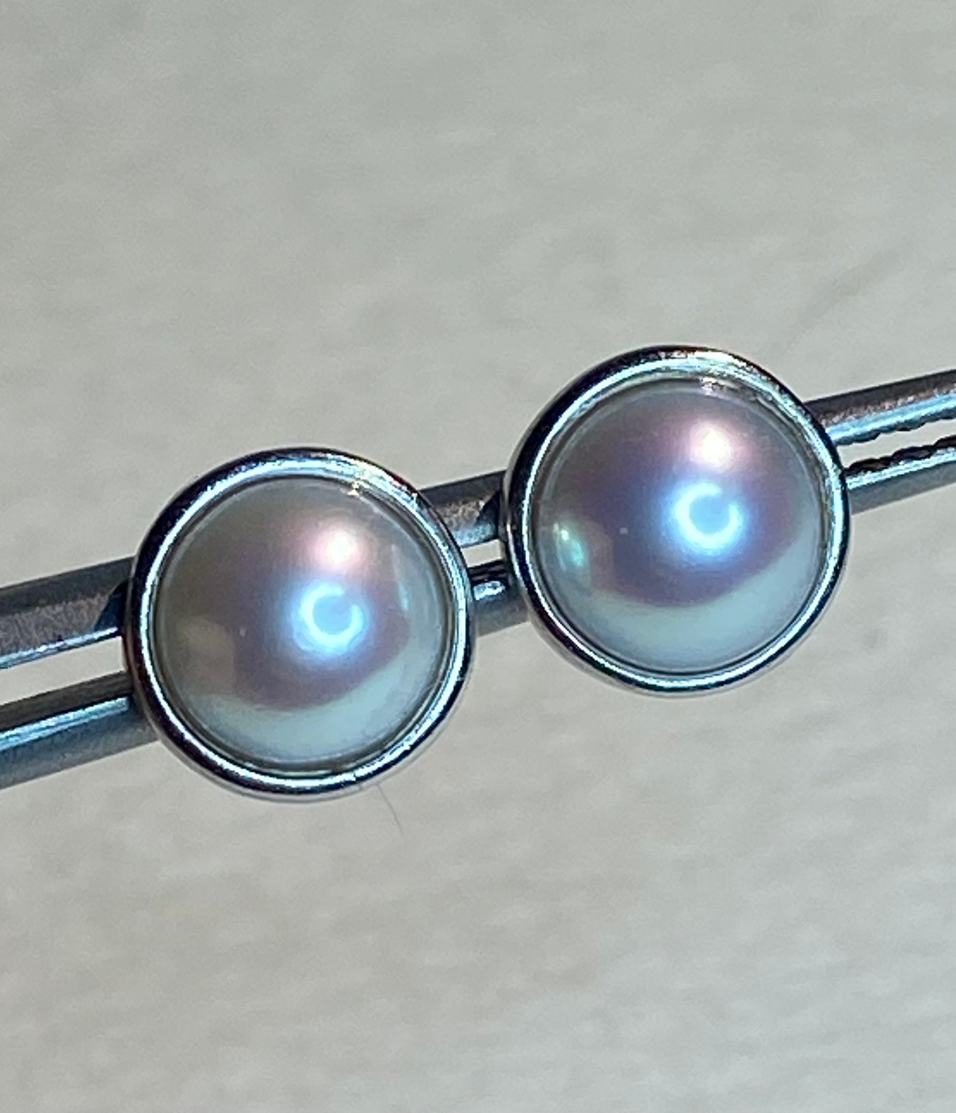Genuine 6.5mm cultured pearl halves in sterling silver bezel stud earrings.