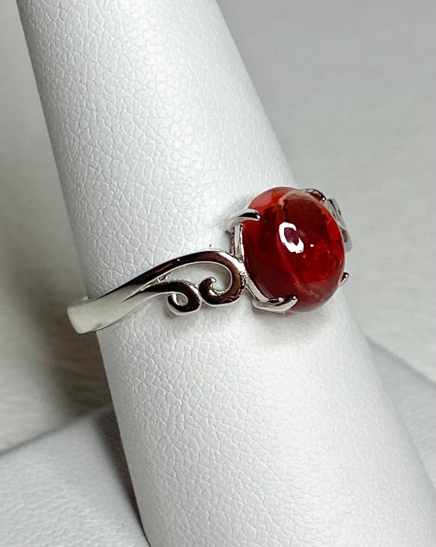 Red Oregon sunstone cabochon swirl ring in solid sterling silver.