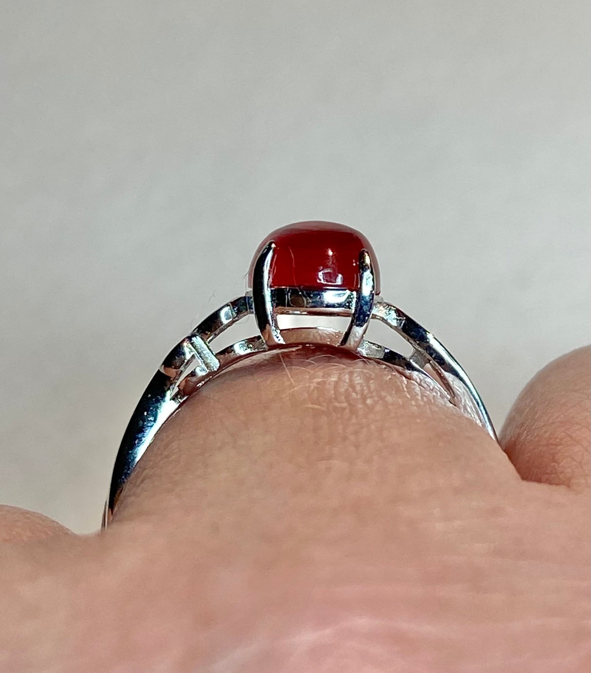 Sterling silver ring with a red Oregon sunstone cabochon.
