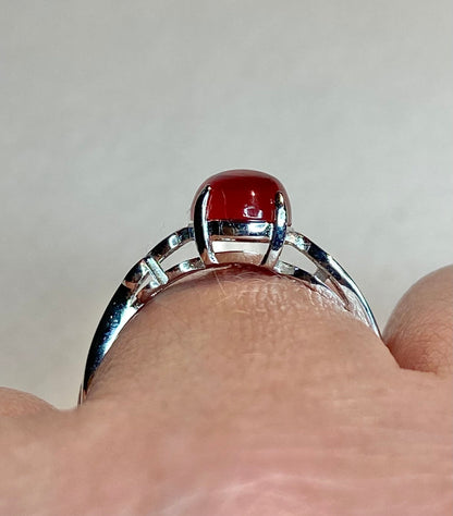Sterling silver ring with a red Oregon sunstone cabochon.