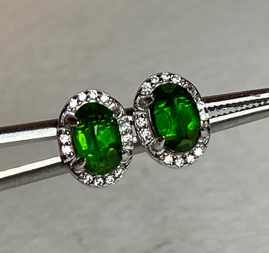 Sterling silver stud earrings with oval chrome diopside and diamond accents.