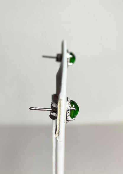 Sterling silver stud earrings with oval chrome diopside gemstones and diamond accents.