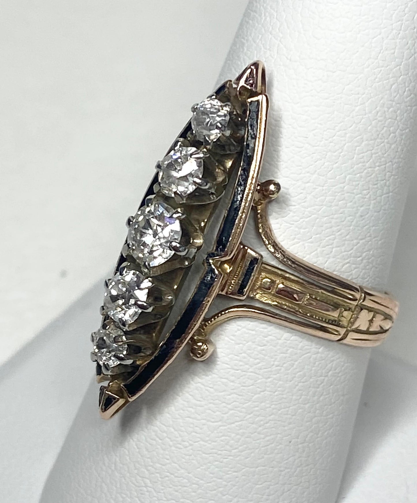 Antique Victorian navette ring with five old mine cut diamonds and black enamel on 14k gold.