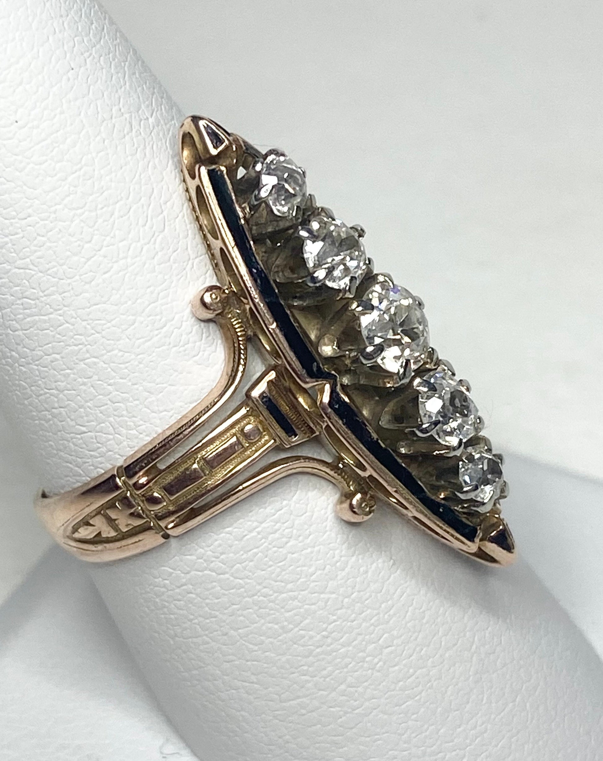 Antique Victorian navette ring with five old mine cut diamonds and black enamel.