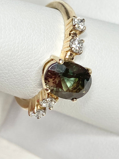 A 10k yellow gold ring with a green Oregon sunstone and four diamonds.