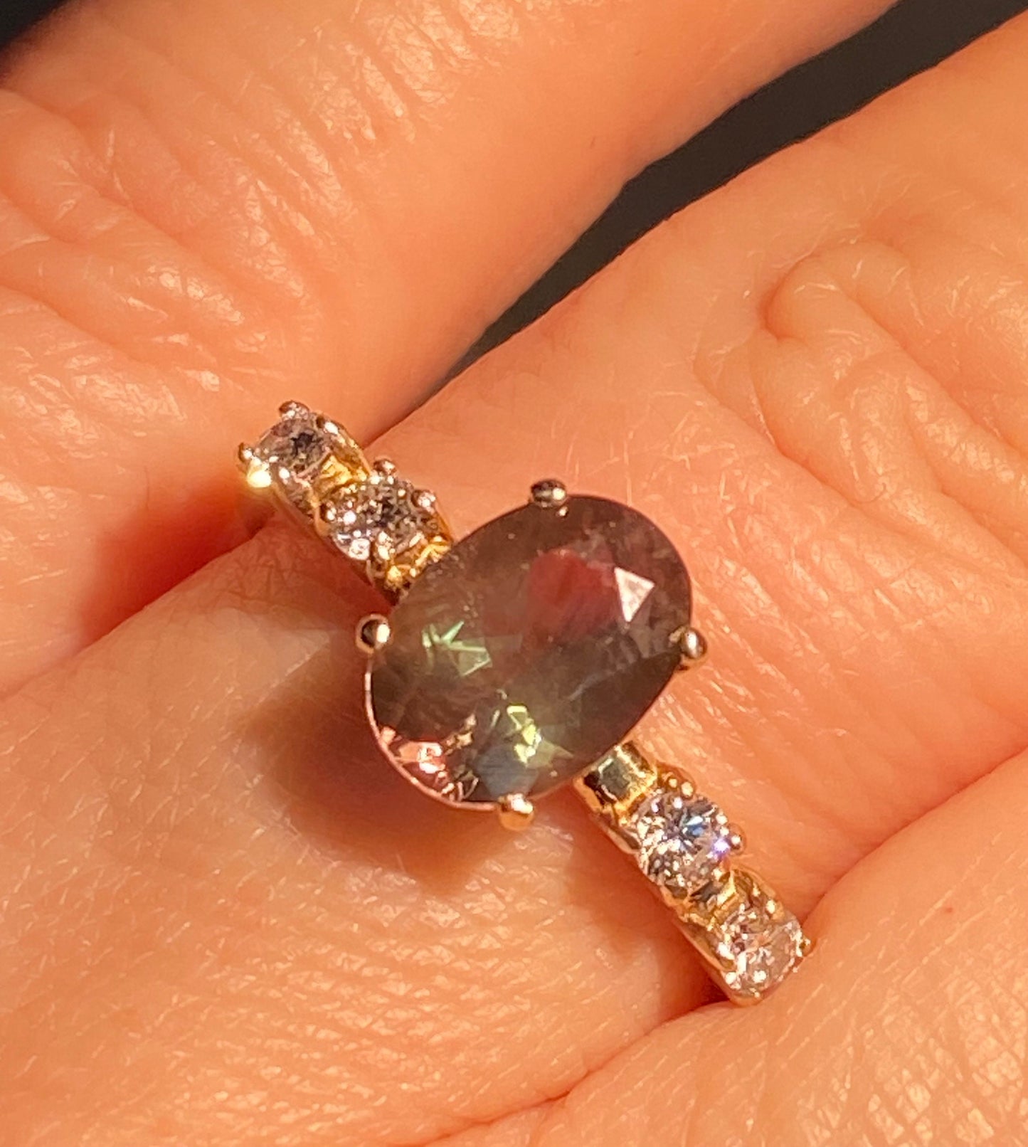 Oval green Oregon sunstone and diamond ring in 10k yellow gold.