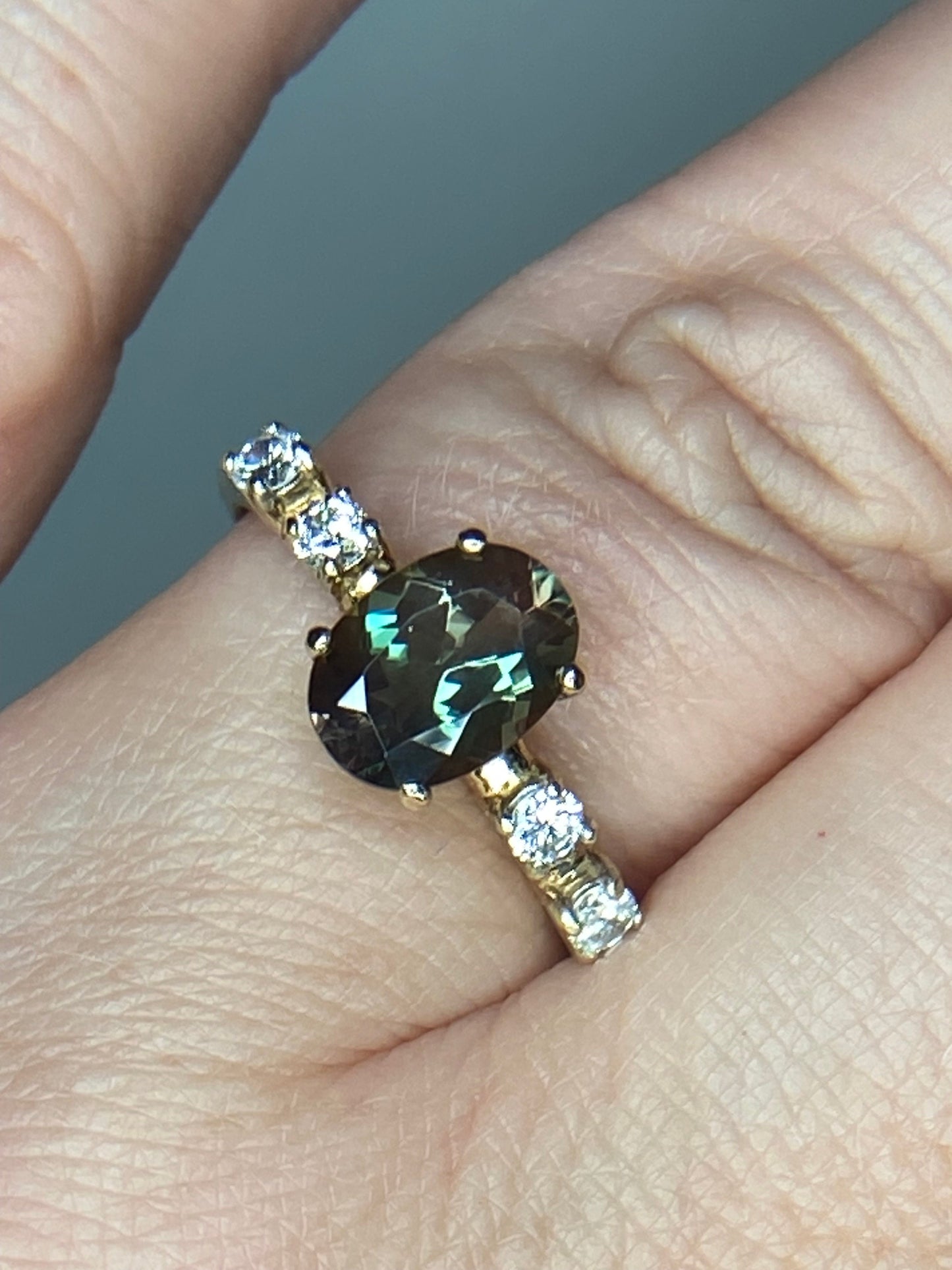 Oval green Oregon sunstone ring with diamonds in 10k yellow gold.