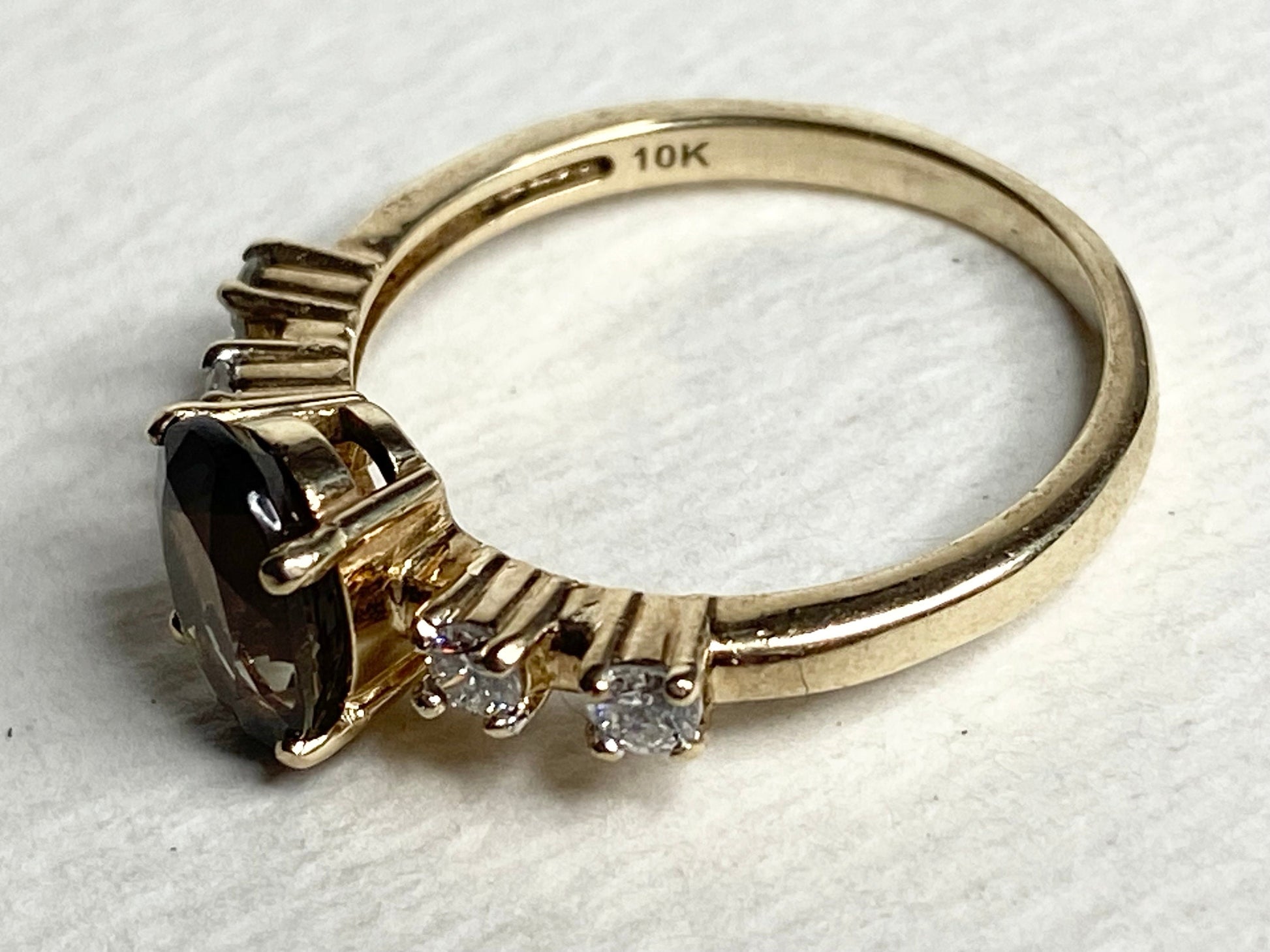 10k yellow gold ring with a green sunstone and diamonds.