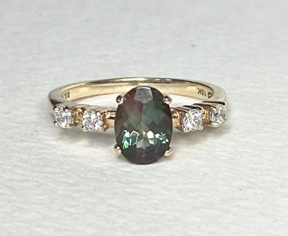 10k yellow gold ring with oval green Oregon sunstone and four diamonds.