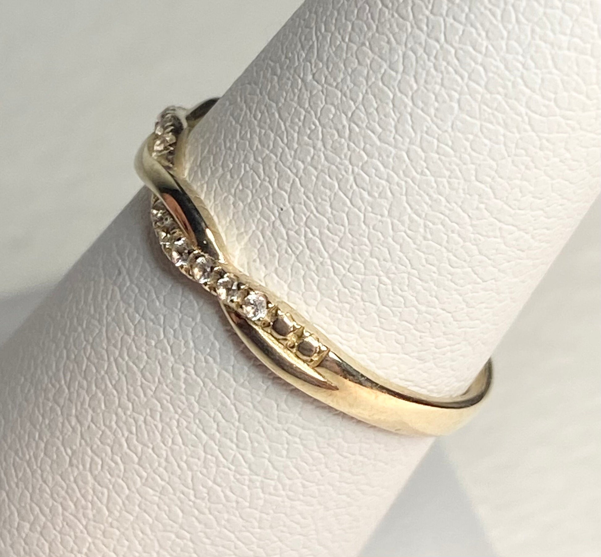 Solid 10k yellow gold twist band ring with pave stones.