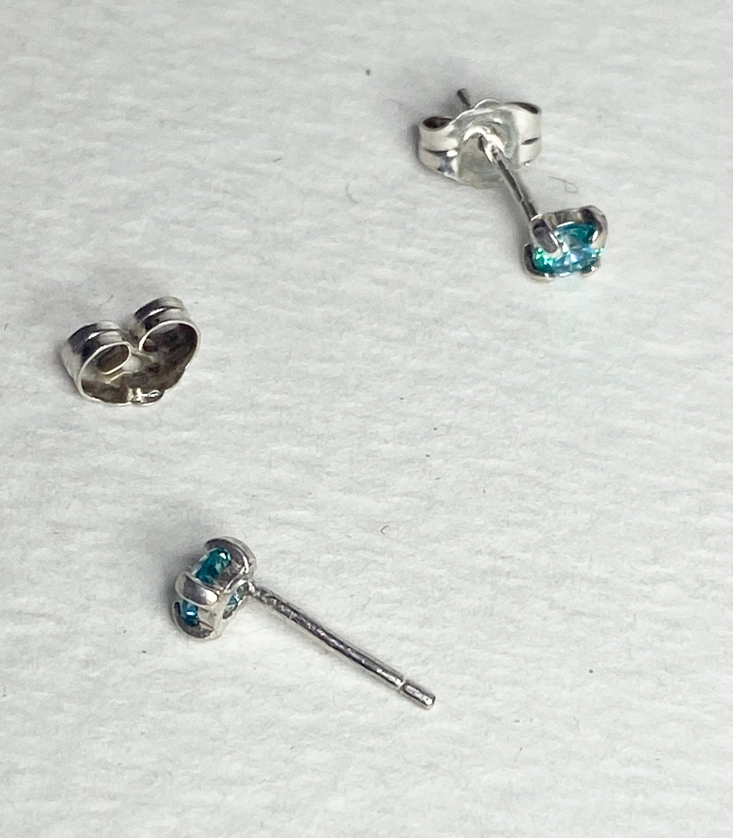 Sterling silver stud earrings with 3.5mm mint aqua Swarovski cubic zirconia.
