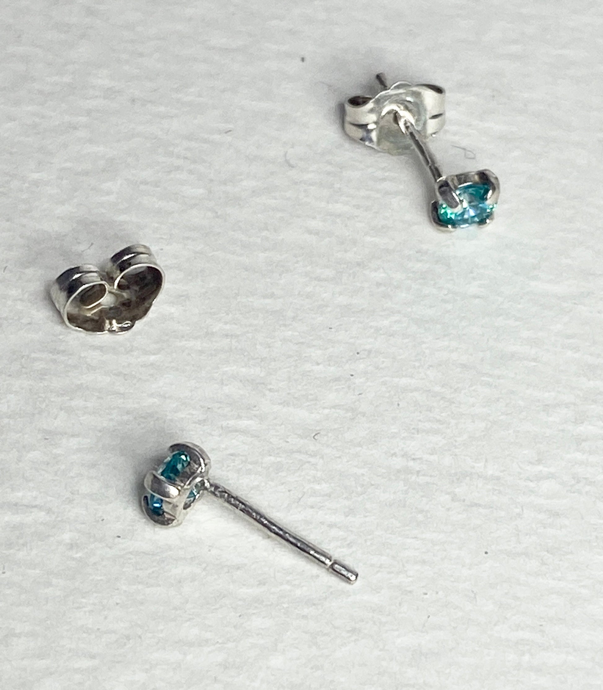 Sterling silver stud earrings with 3.5mm mint aqua Swarovski cubic zirconia.