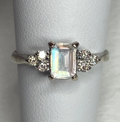 Emerald cut rainbow moonstone ring with diamonds in 14k white gold.
