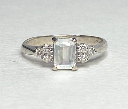 14k white gold ring with emerald-cut rainbow moonstone and diamonds.