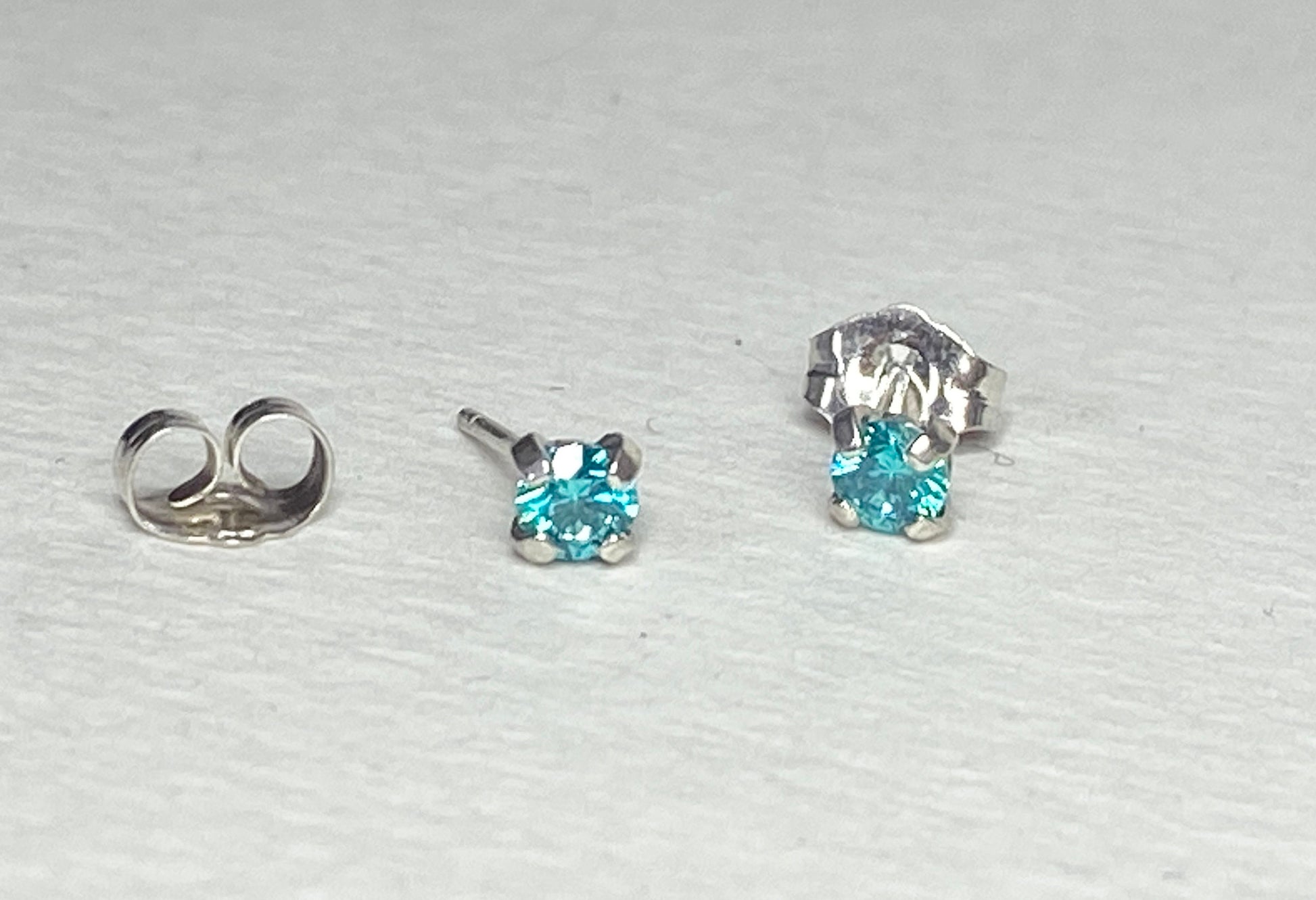 Sterling silver stud earrings with 3.5mm mint aqua Swarovski cubic zirconia.