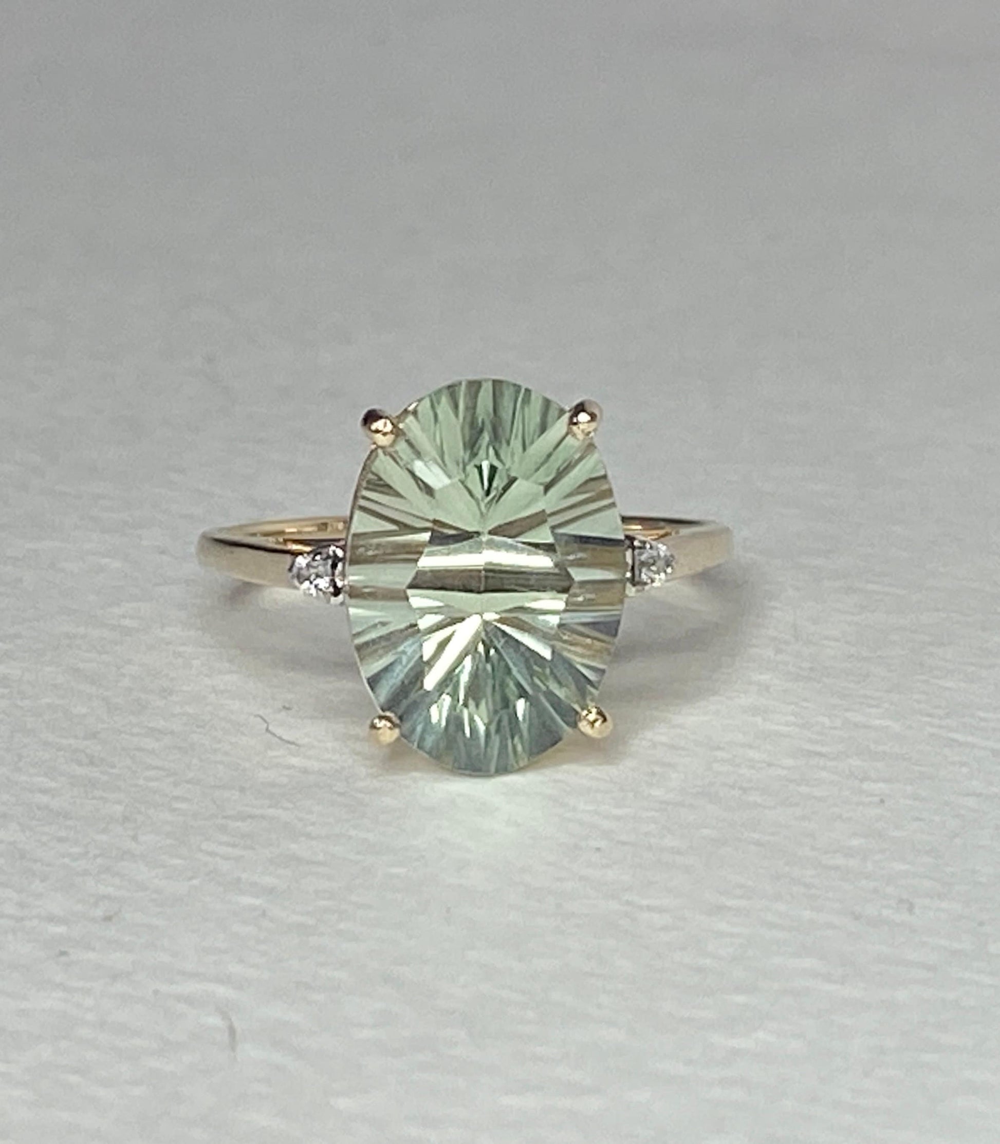 Oval fancy cut prasiolite quartz ring with zircon accents in 9k yellow gold.