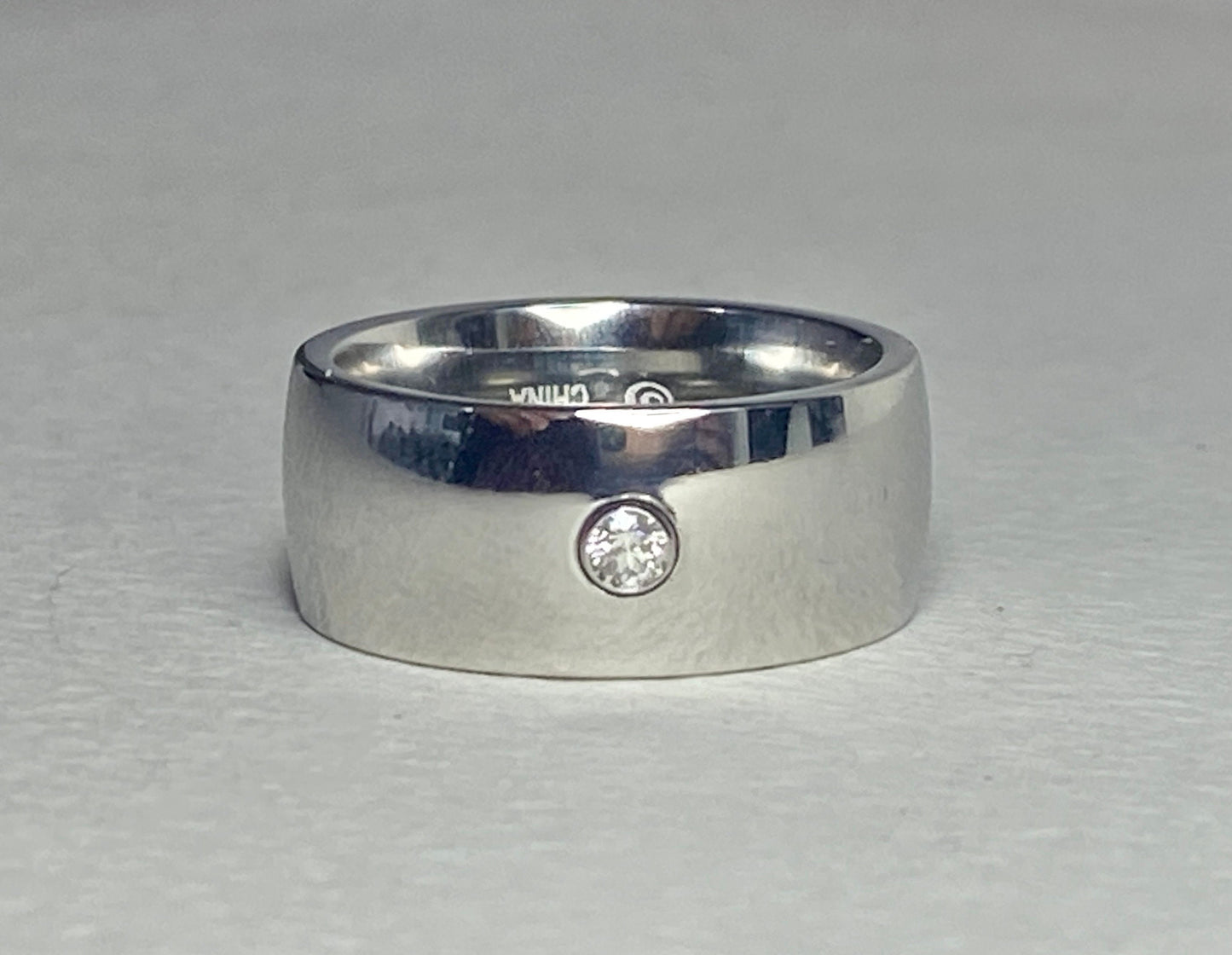Hefty cobalt band ring with a single diamond, size 10.
