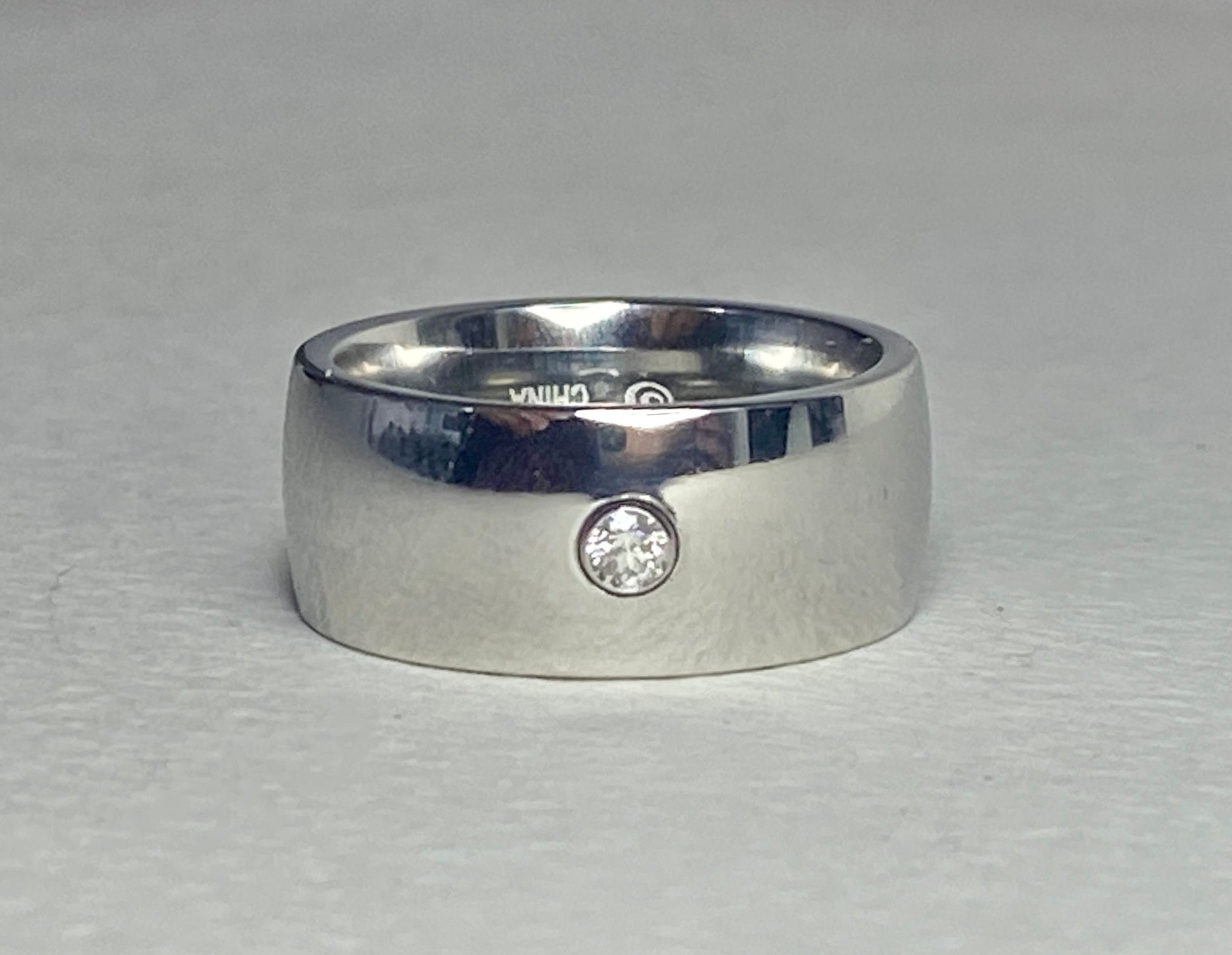 Hefty cobalt band ring with a single diamond, size 10.