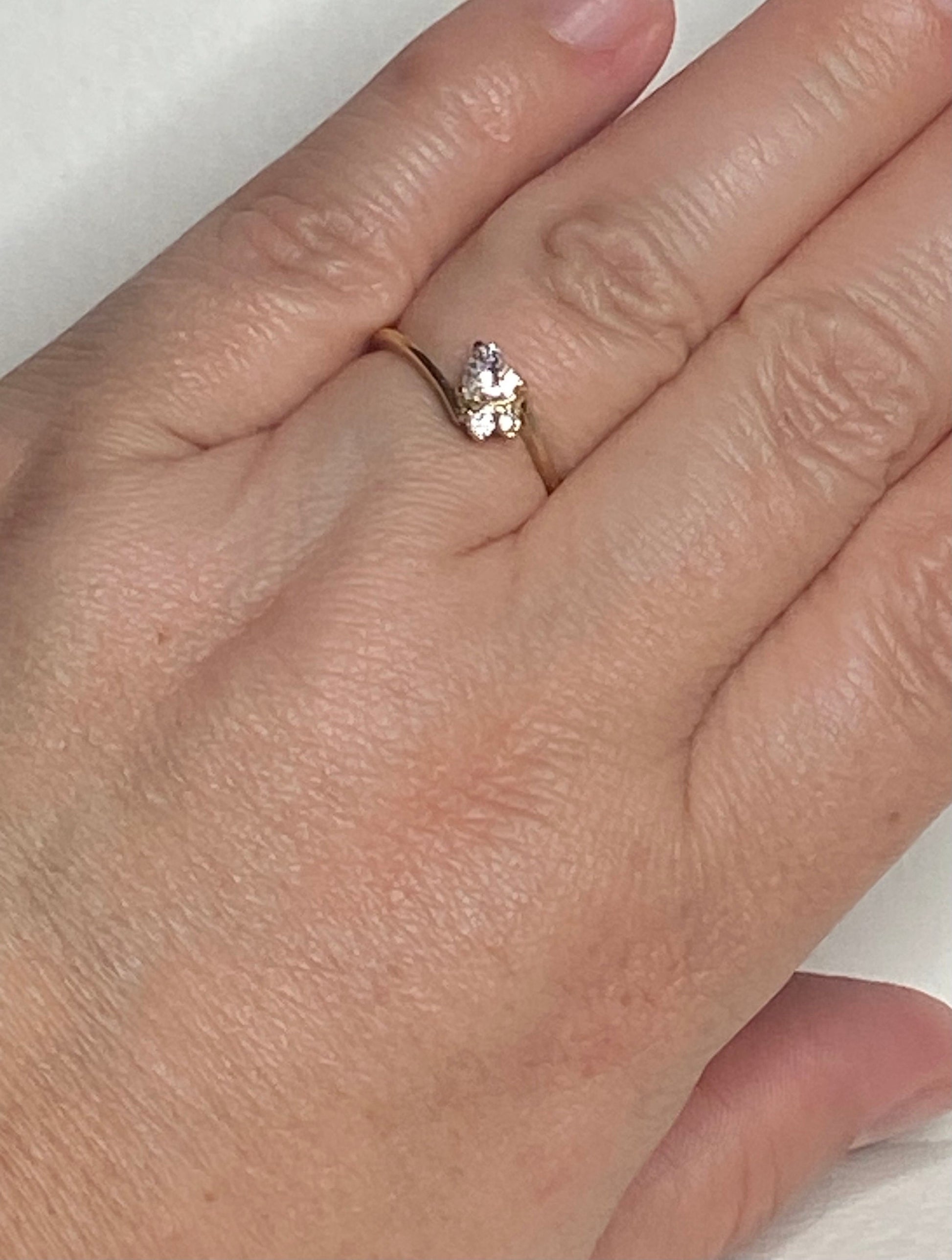 14k gold ring with a heart-shaped diamond and two accent diamonds.