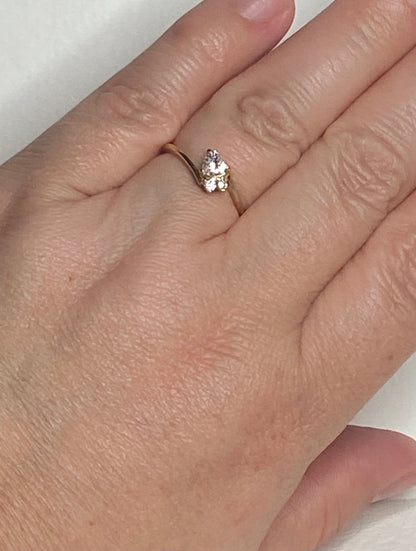 14k gold ring with a heart-shaped diamond and two accent diamonds.