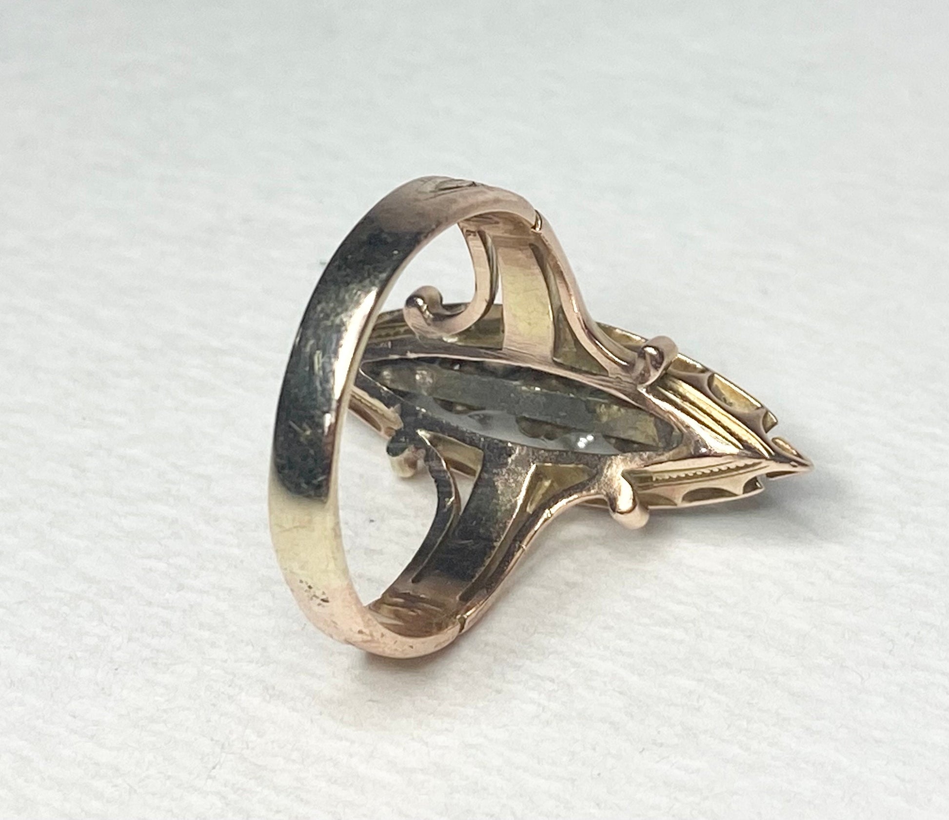 Antique Victorian navette ring with diamonds and black enamel in 14k gold.