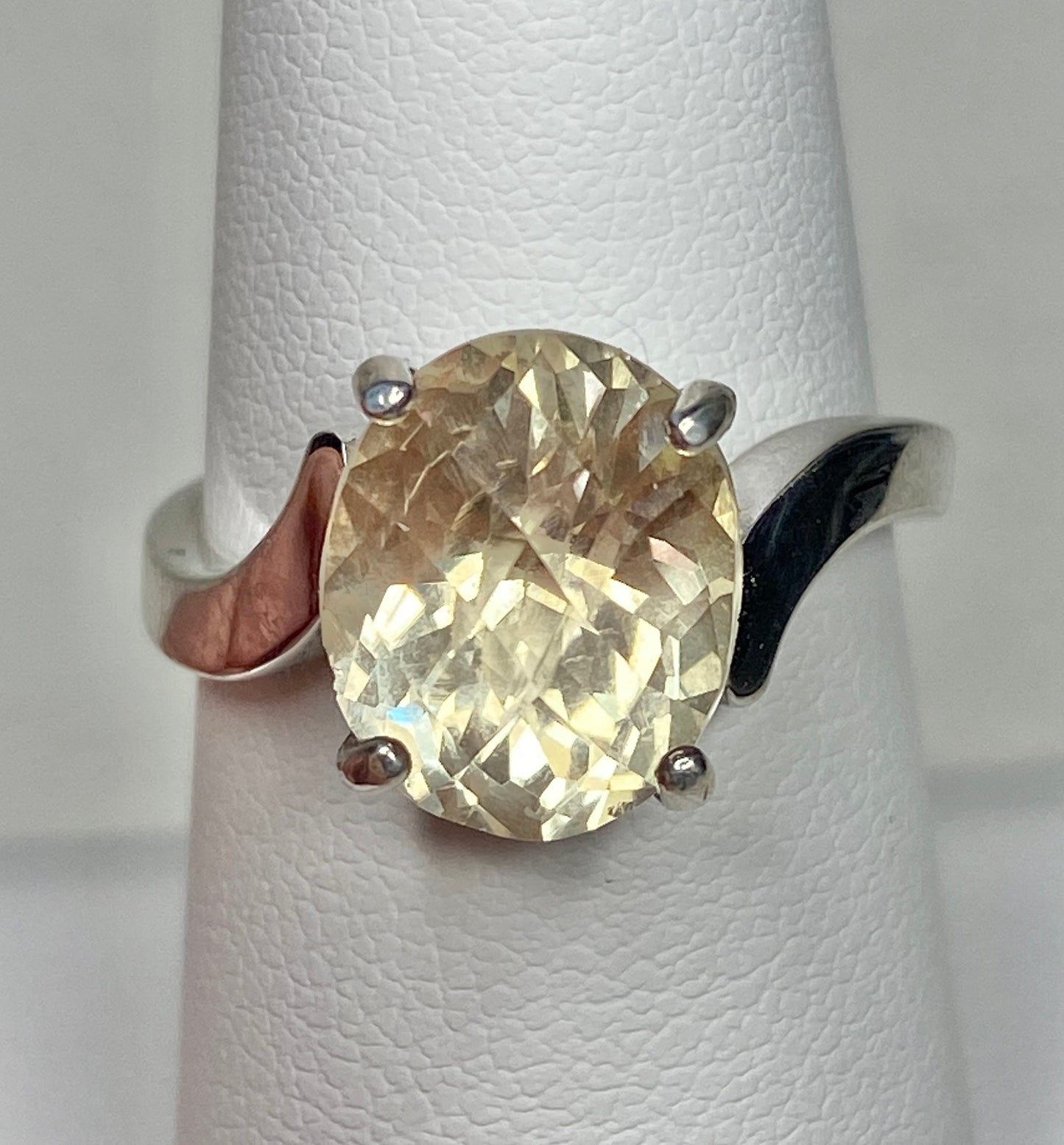 Oval checkerboard faceted Oregon sunstone solitaire ring in sterling silver.