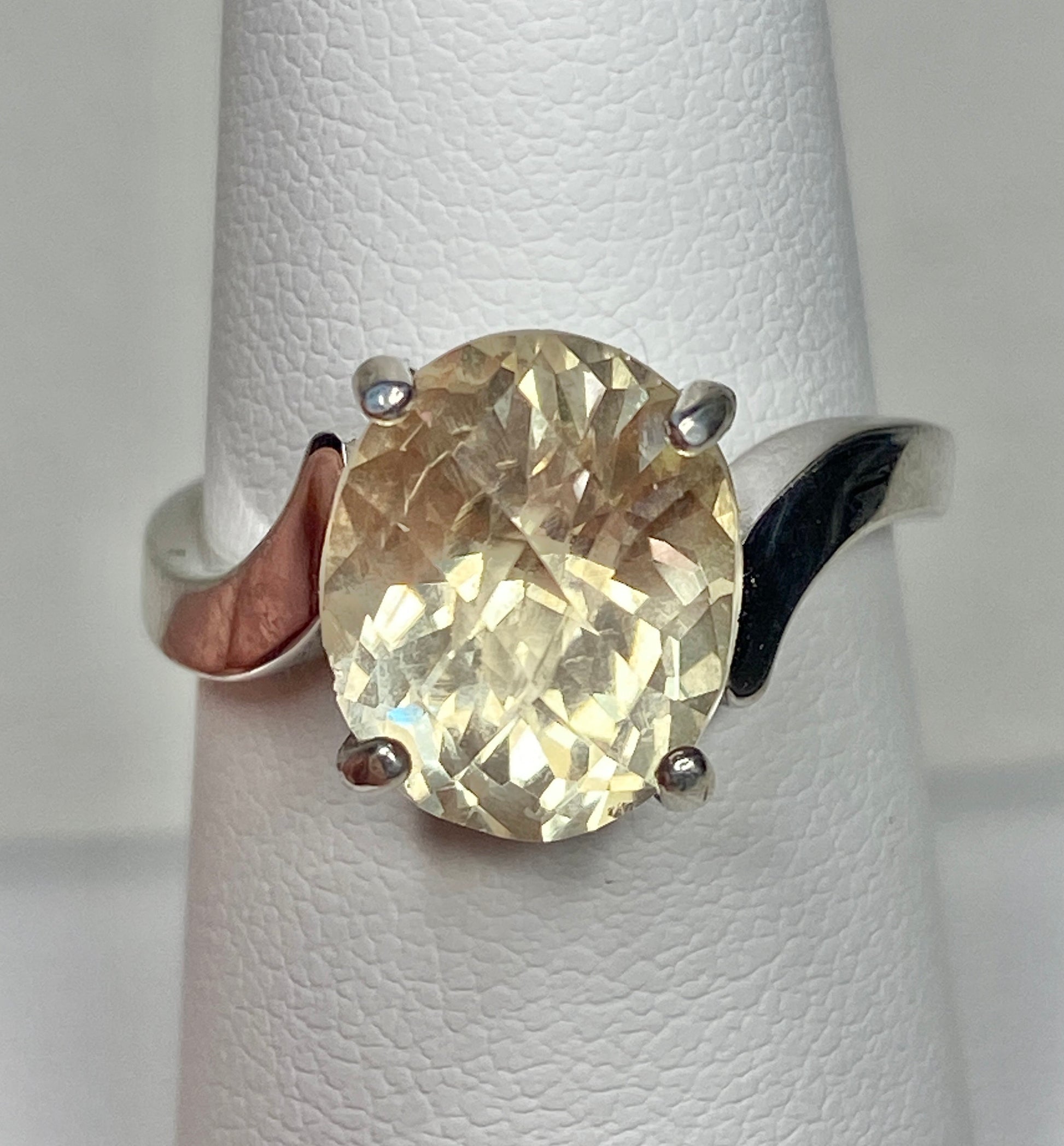 Oval checkerboard faceted Oregon sunstone solitaire ring in sterling silver.