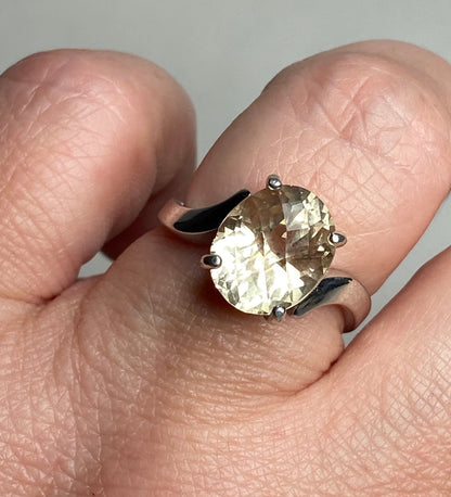 Oval checkerboard faceted Oregon sunstone solitaire ring in sterling silver.