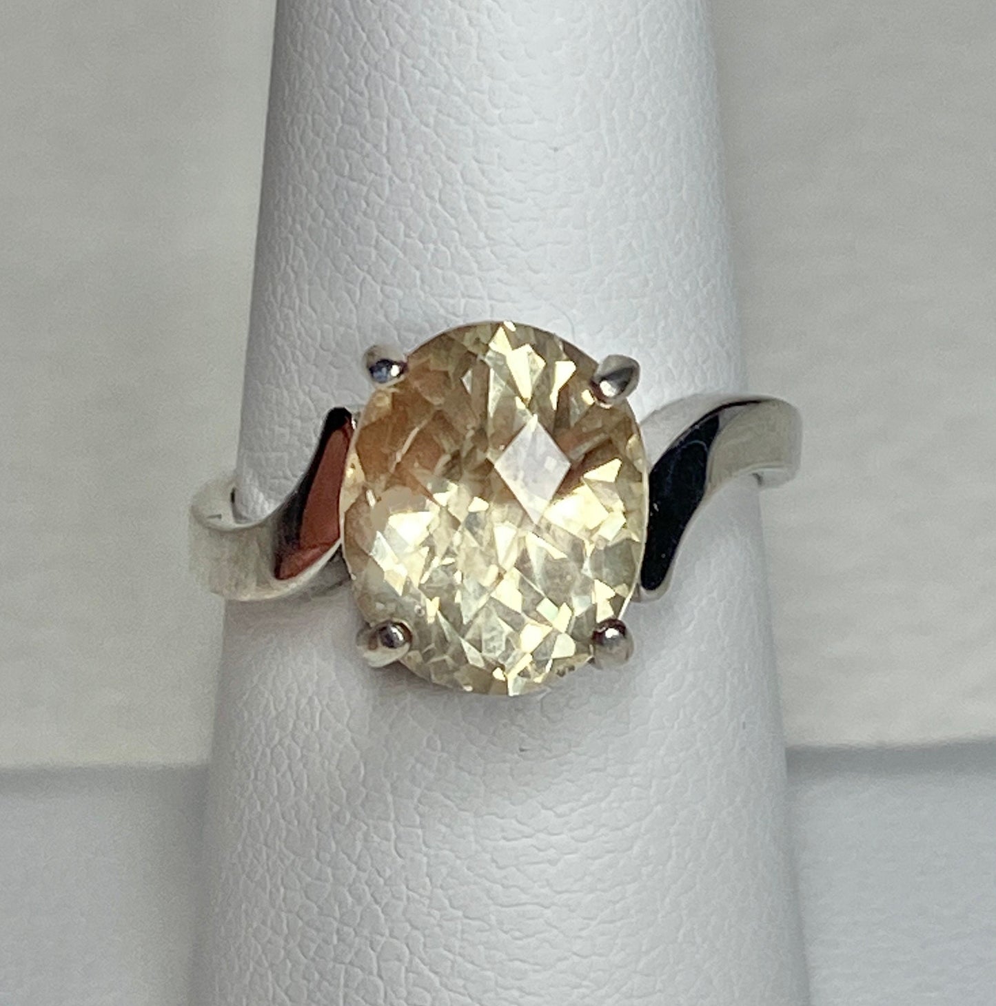 Sterling silver ring with a checkerboard faceted oval Oregon Sunstone.