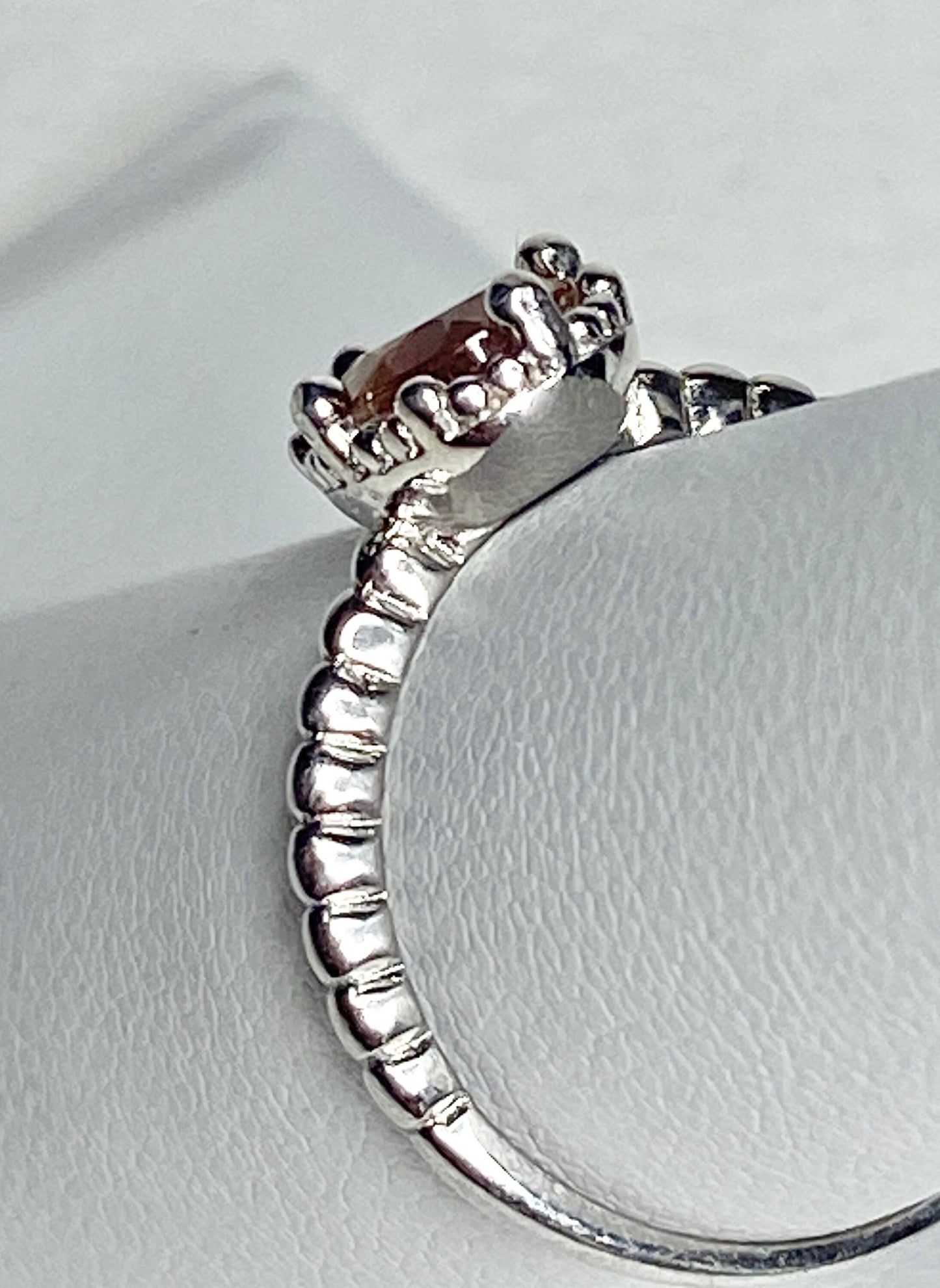 Sterling silver ring with a peach Oregon sunstone and beaded band.