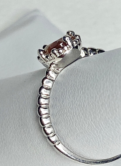 Sterling silver ring with a peach Oregon sunstone and beaded band.