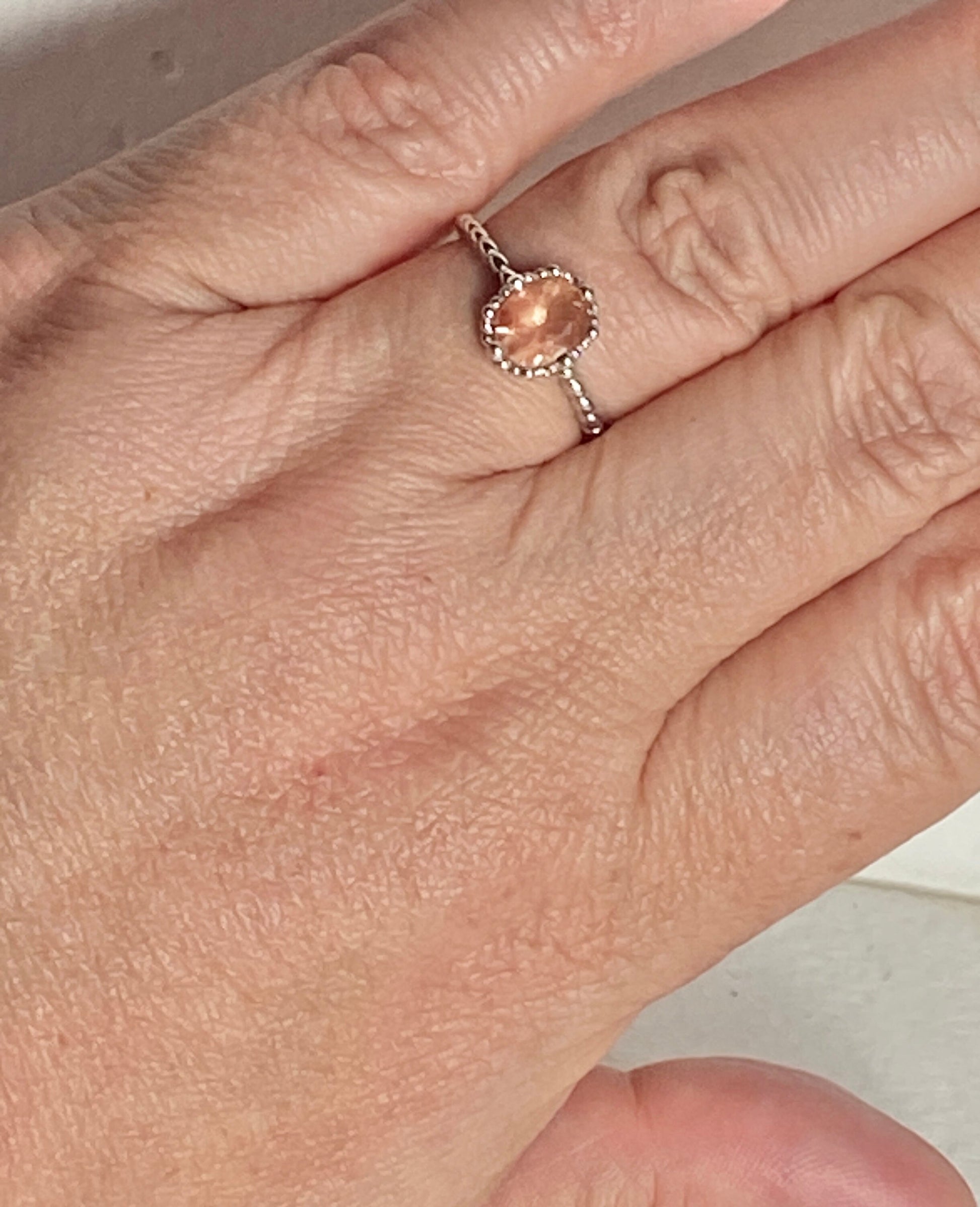Sterling silver ring with a peach oval Oregon Sunstone.