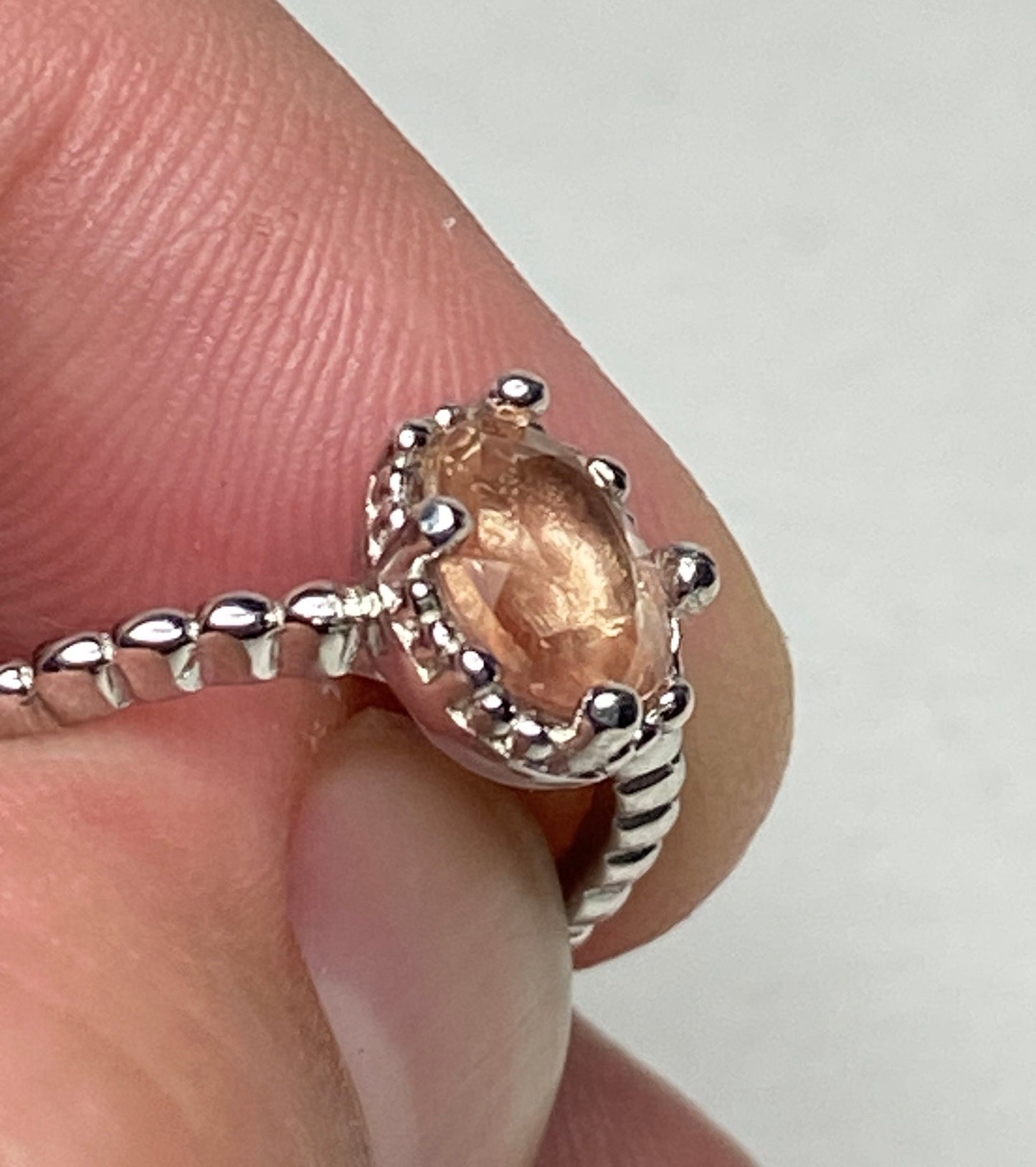 Sterling silver ring with a peach oval Oregon Sunstone and beaded details.