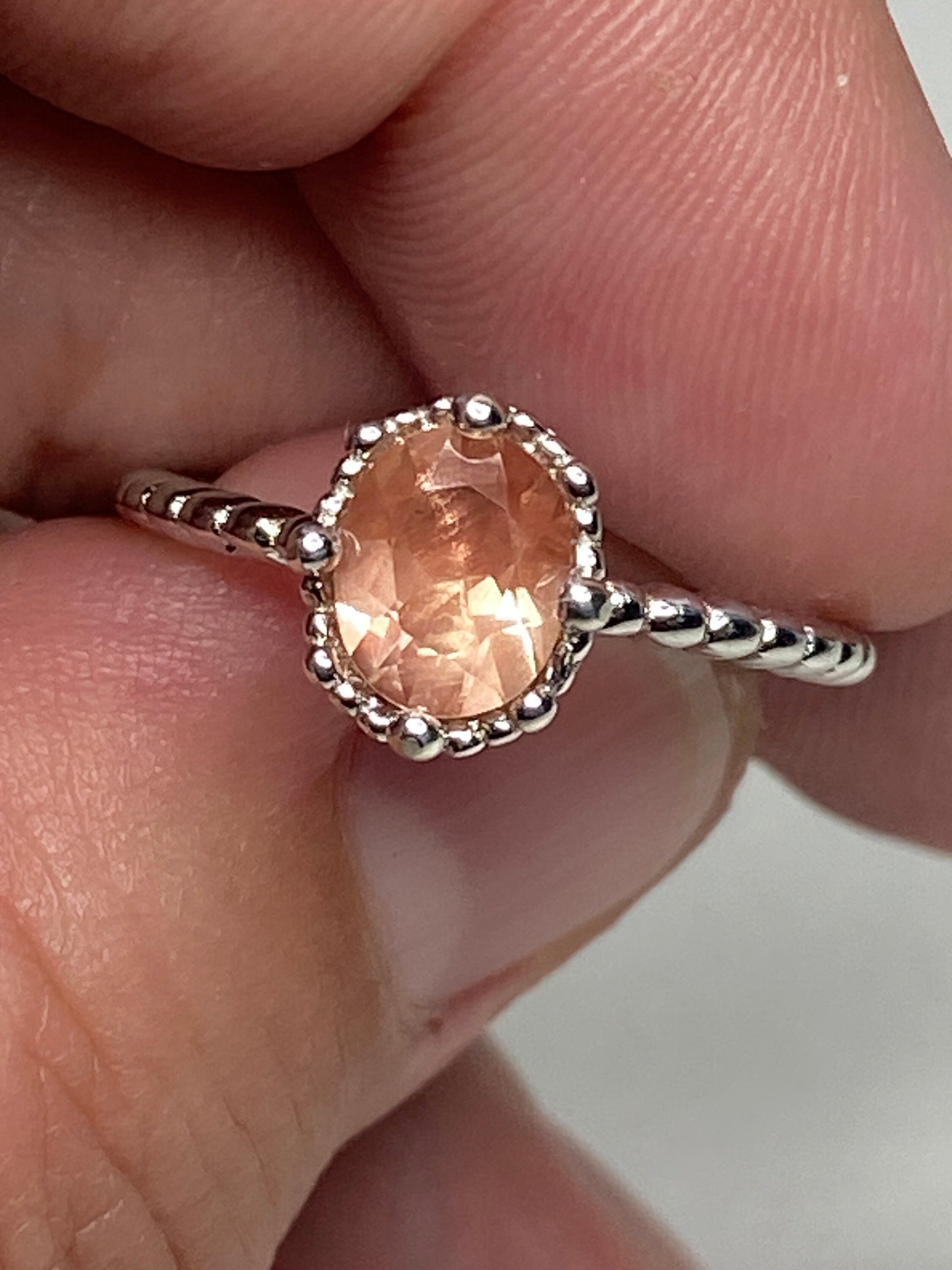 Sterling silver ring with a peach oval Oregon Sunstone and beaded design.
