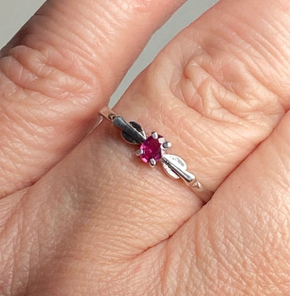 Sterling silver ring with a petite oval Burmese ruby in a spade arrowhead design.