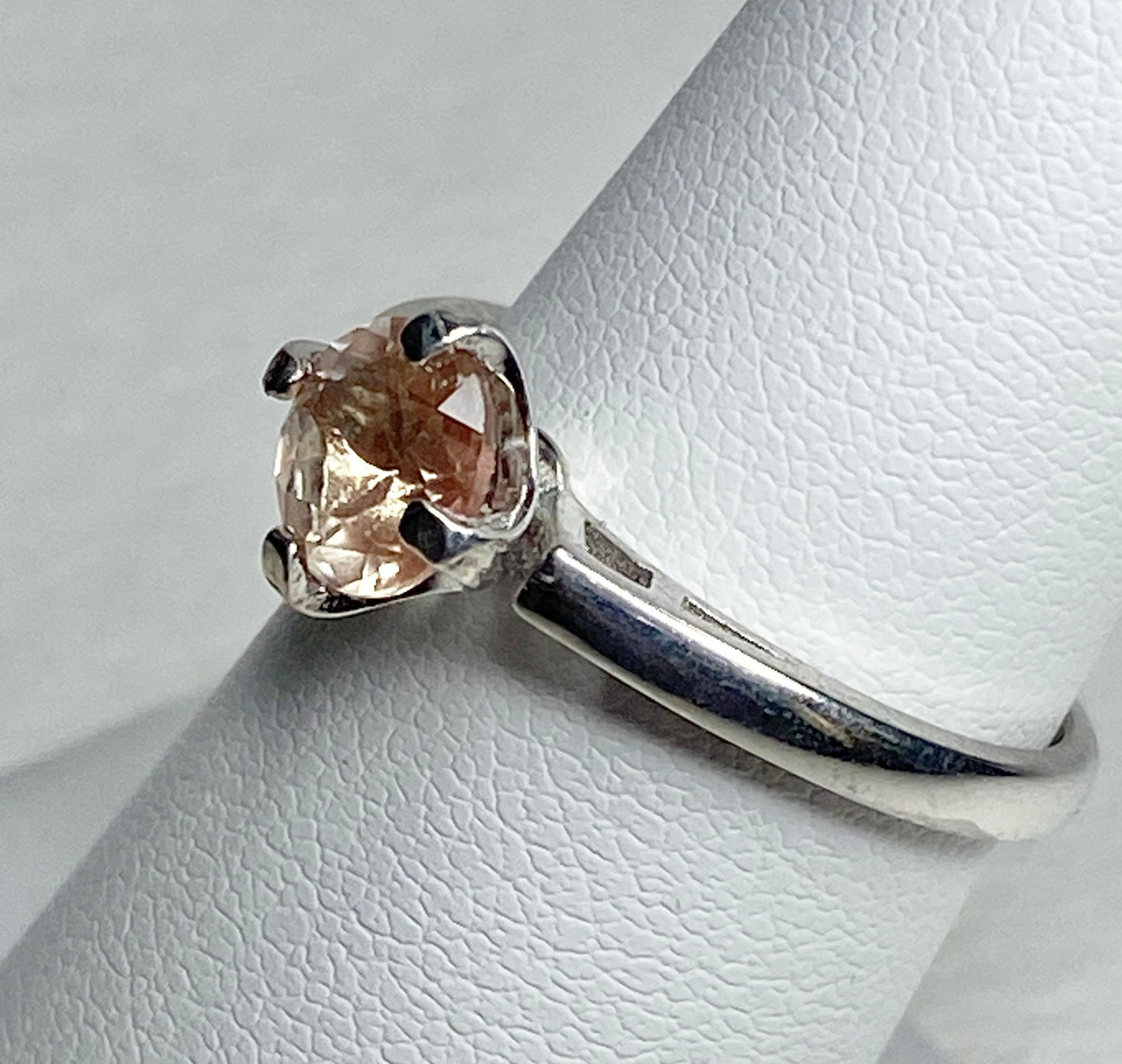 Sterling silver ring with a round, light peach Oregon sunstone.