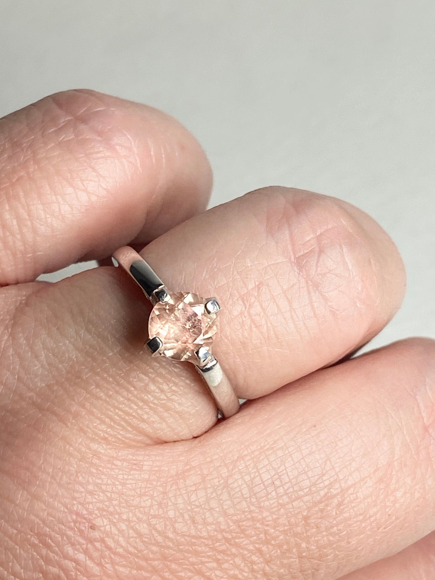 Sterling silver ring with a round, light peach Oregon sunstone.