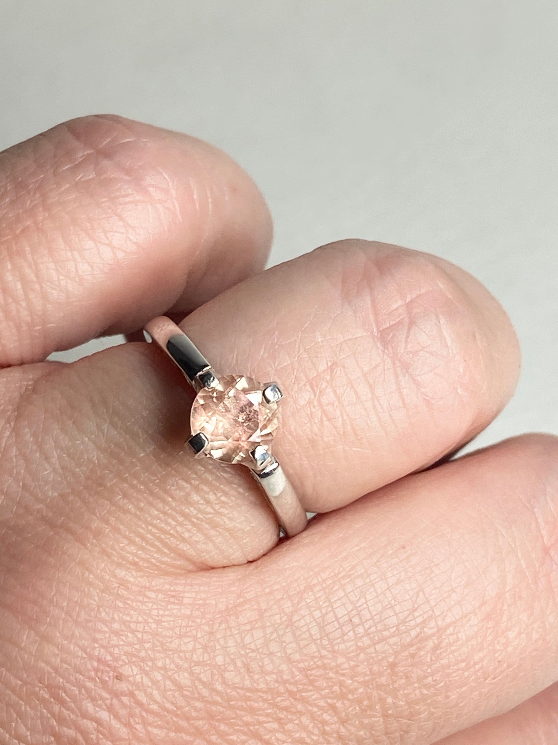 Sterling silver ring with a round, light peach Oregon sunstone.