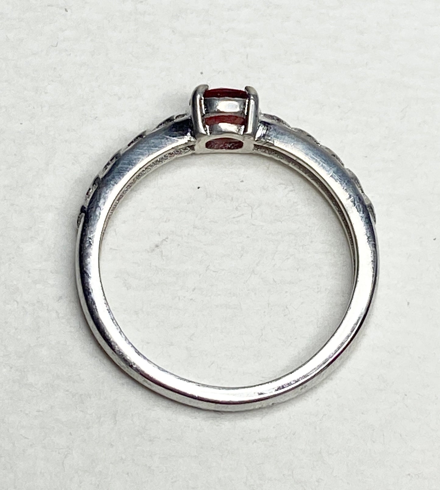 Sterling silver ring with a light red Oregon sunstone and diamond trellis design.