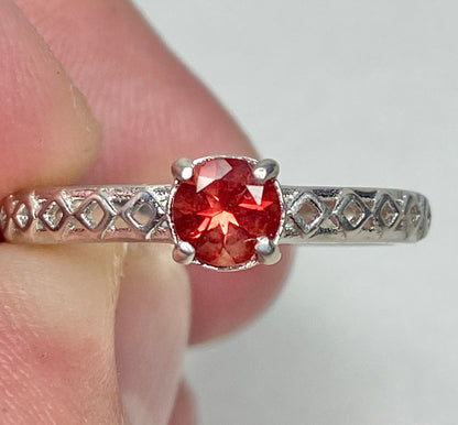 Sterling silver ring with a light red Oregon sunstone and diamond trellis design.